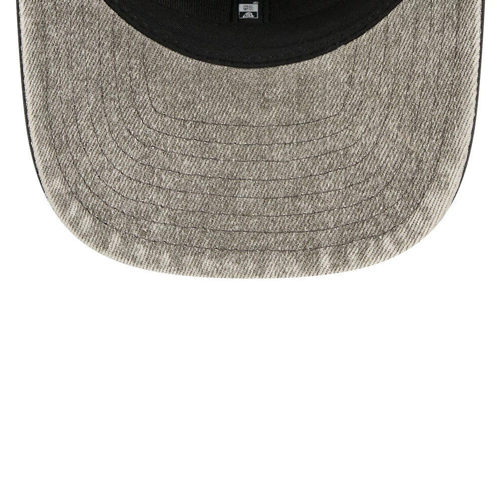 Las Vegas Raiders NFL Washed Denim Dark Grey New Era 9SEVENTY Stretch Snap Cap, inside view showing the washed denim dark grey undervisor with stitching, a black sweatband and the New Era taping across the interior.