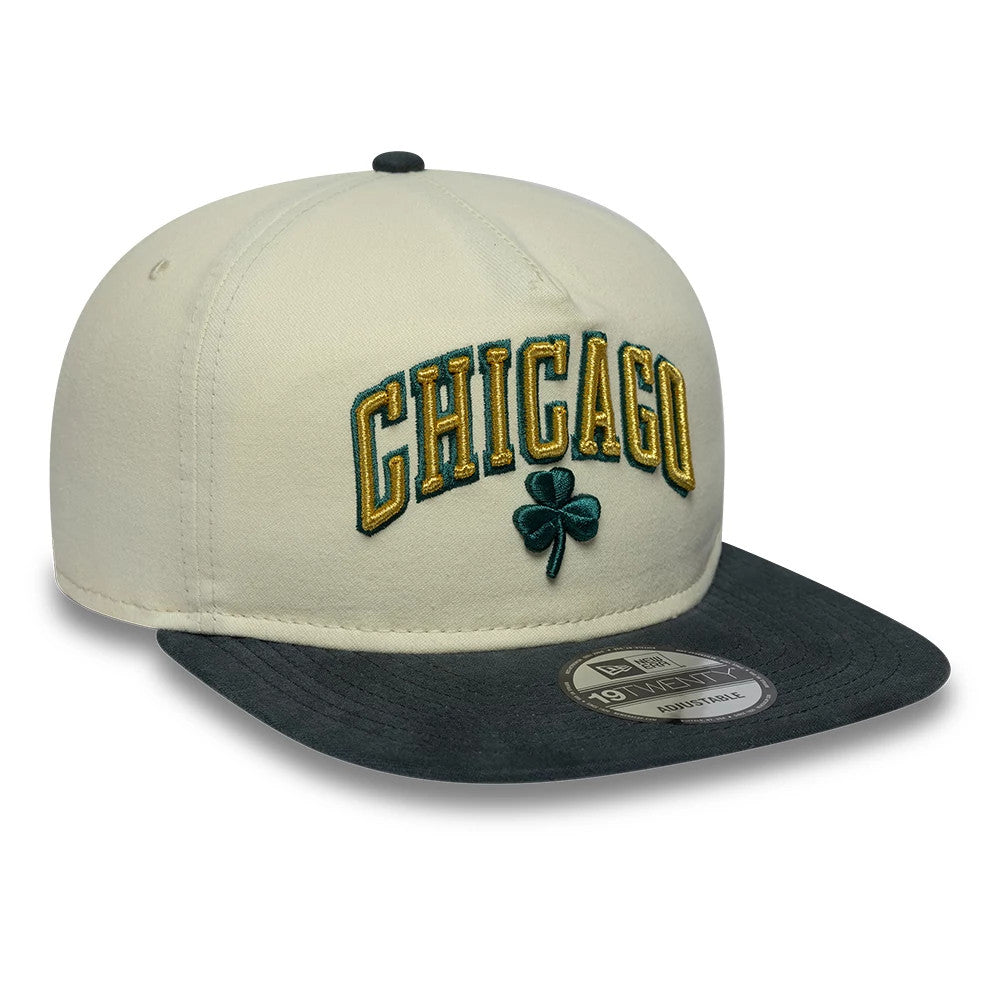 Chicago Bulls NBA Metallic Logo Cream New Era 19TWENTY Adjustable Cap, front view showing the raised gold embroidered Chicago lettering and green clover emblem on the cream front panels, with a contrasting dark visor and a 19TWENTY size sticker.