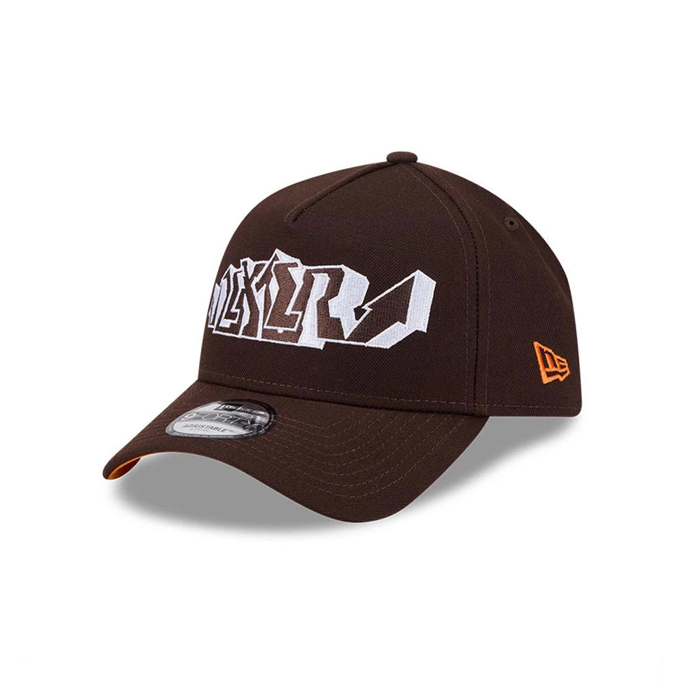Dexter's Laboratory Dark Brown New Era 9FORTY A-Frame Adjustable Cap, front view showing the white embroidered Dexter's Laboratory logo on the structured brown crown, with an orange New Era flag logo on the left side.