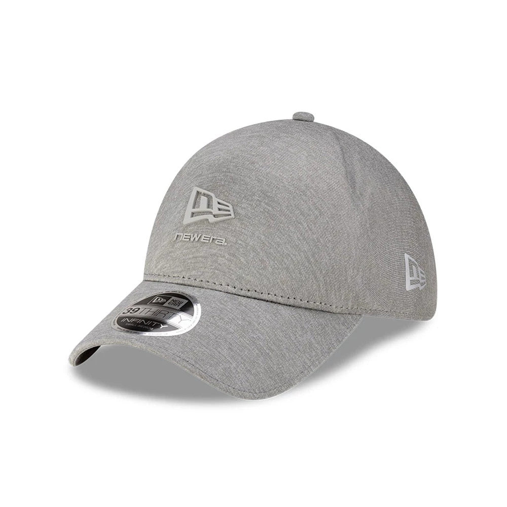 New Era Grey 39THIRTY Infinity Stretch Fit Cap, three-quarter view showing a raised New Era flag logo in silver embroidery on the front panel, 39THIRTY size sticker on a curved grey visor, and an additional logo on the left side.