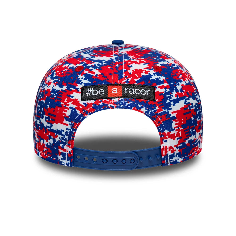 Aprilia Replica Le Mans Race Special Blue New Era 9SEVENTY Stretch Snap Adjustable Cap, rear view showing the black and white embroidered #be a racer patch on the structured blue and red pixel pattern crown, with a matching blue snap closure.