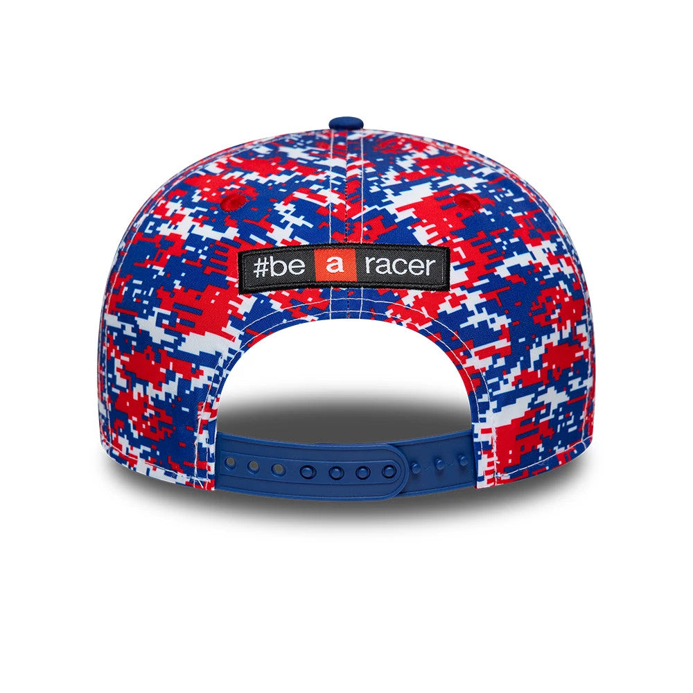 Aprilia Replica Marco Bezzecchi Le Mans Race Special Blue New Era 9SEVENTY Stretch Snap Adjustable Cap, rear view showing the woven #be a racer patch on a blue, red, and white digital camo crown, with a blue adjustable snap closure.