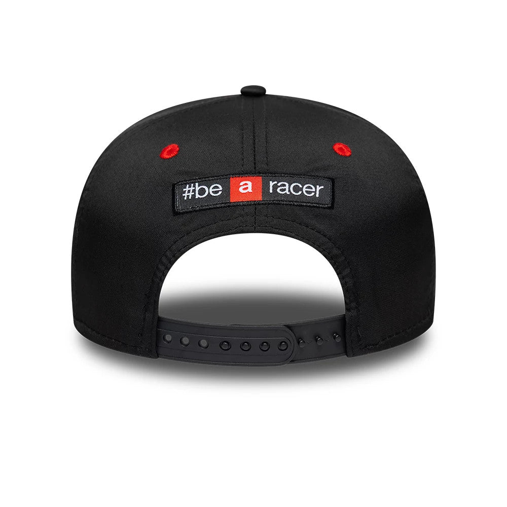 Aprilia Team White New Era 9SEVENTY Stretch Snap Adjustable Cap, rear view showing the embroidered #be a racer text patch across the back panels, with red eyelets on a black structured crown above a black adjustable snap closure.