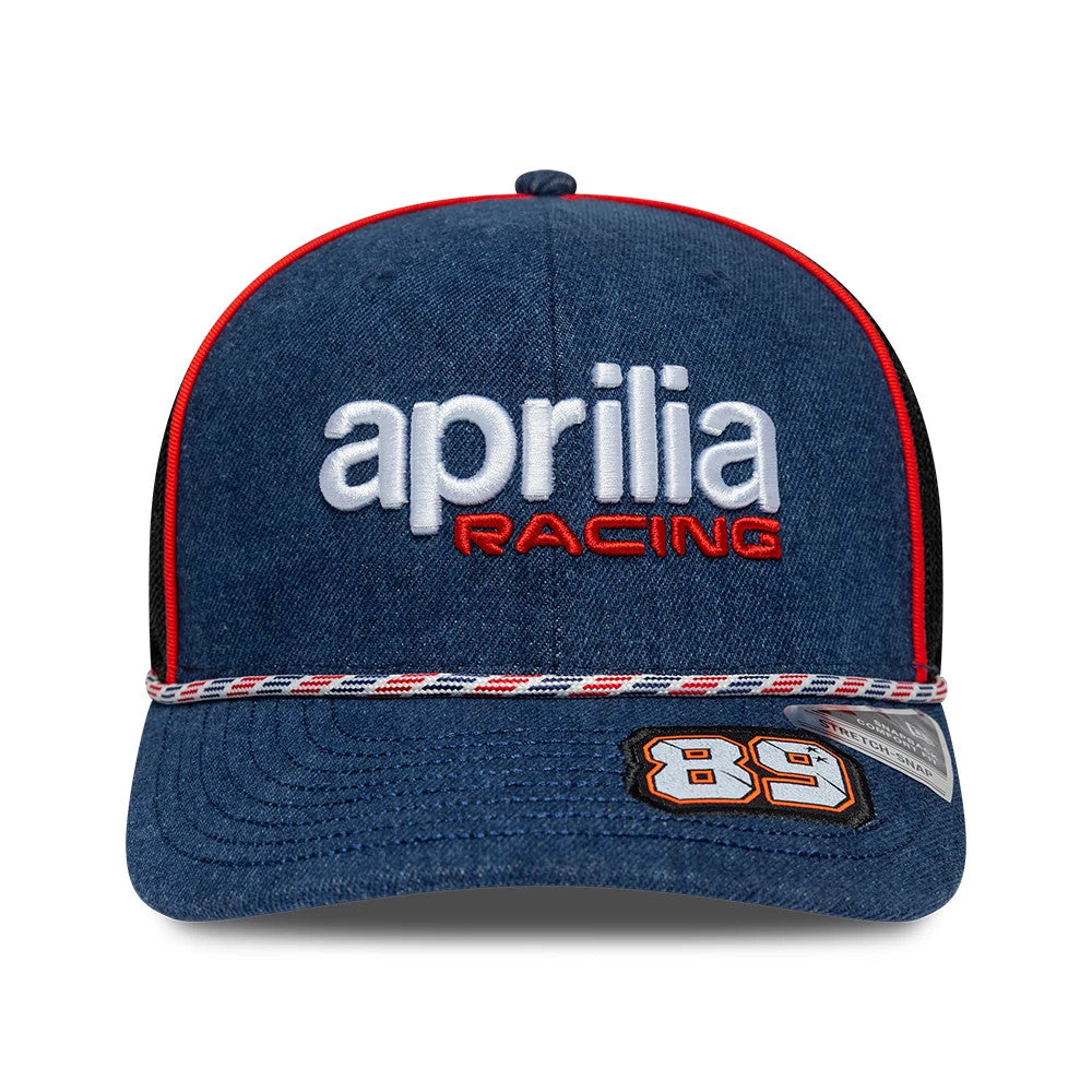 Aprilia Replica Jorge Martin Austin Race Special Blue New Era 9SEVENTY Stretch Snap Adjustable Cap, front view showing a prominent white and red embroidered Aprilia Racing logo, a textured blue visor with a red and white checkered trim, and 89 patch.