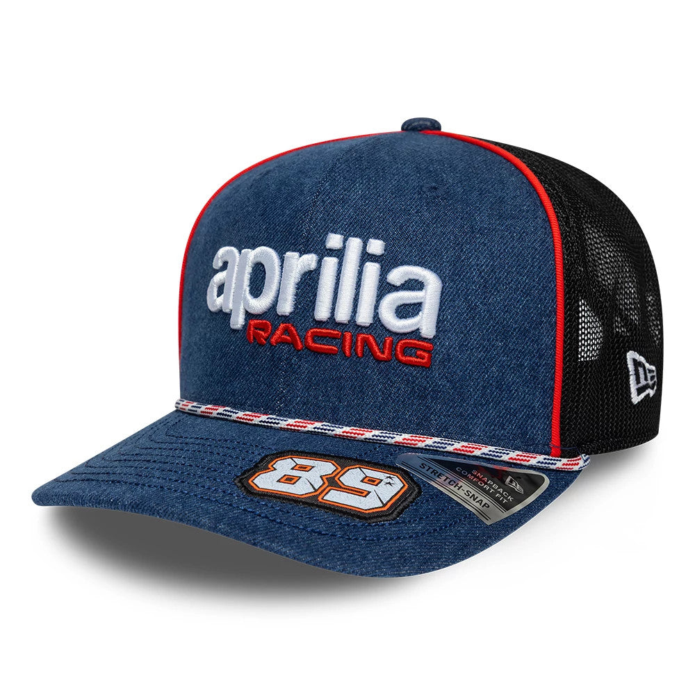 Aprilia Replica Jorge Martin Austin Race Special Blue New Era 9SEVENTY Stretch Snap Adjustable Cap, front view showing large white 'aprilia' and red 'RACING' embroidery on the blue crown, a striped red, white, and blue band above the visor.