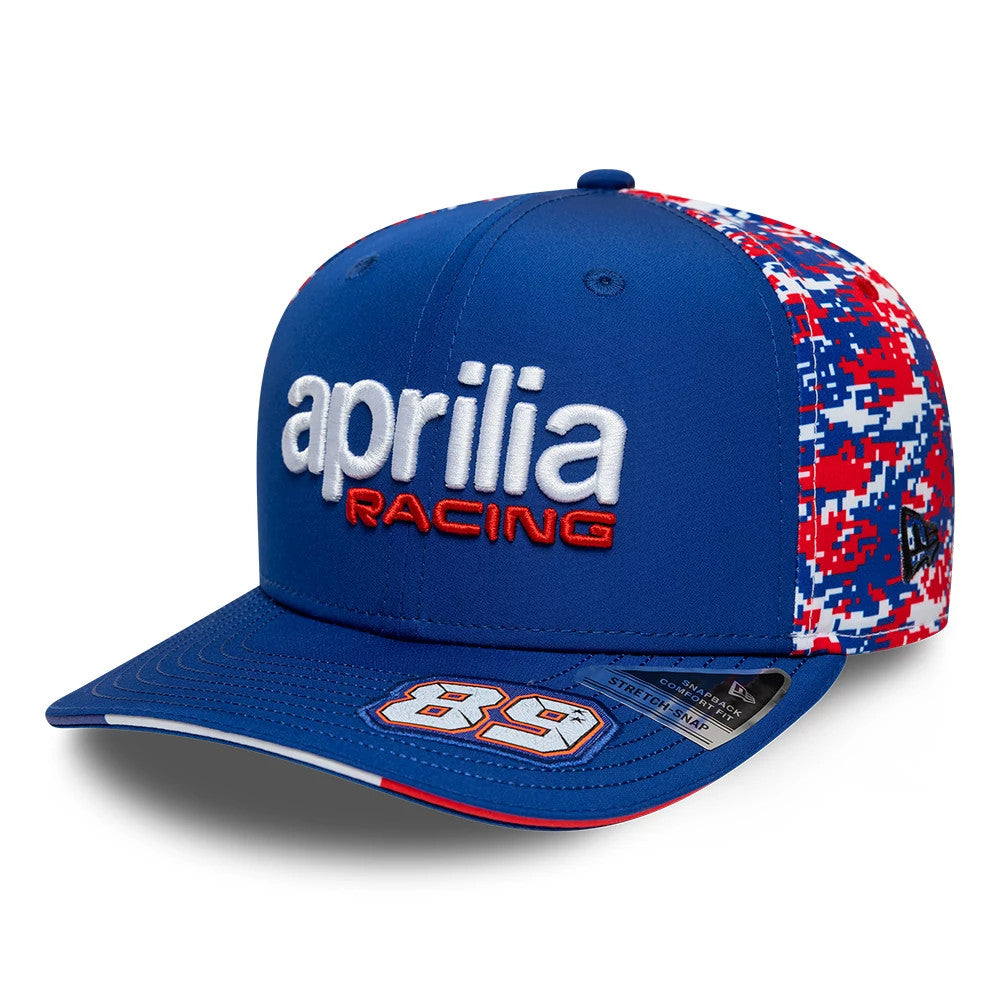 Aprilia Replica Jorge Martin Le Mans Race Special Blue New Era 9SEVENTY Stretch Snap Adjustable Cap, front view showing white and red embroidered Aprilia Racing logo, blue visor with 89 graphic, and digital camo side panels.