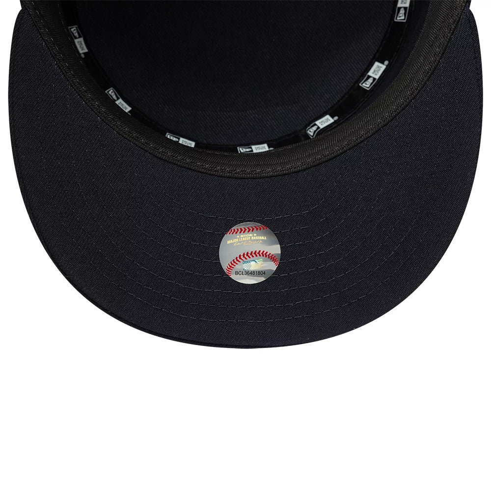 New Era New York Yankees MLB Poly Navy Pillbox Adjustable Cap, inside view showing the dark navy undervisor, a round baseball-themed sticker, and black sweatband with repeating New Era logos, complemented by matching manufacturer taping.