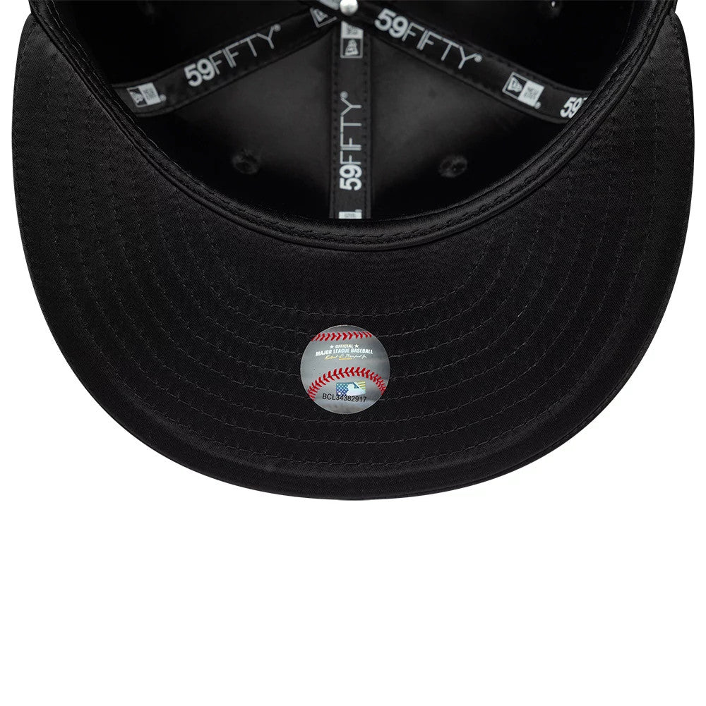 Chicago White Sox MLB Satin Black New Era 59FIFTY Fitted Cap, inside view showing black 59FIFTY taping across the panels, a matching black sweatband, and a baseball-themed sticker on the undervisor.