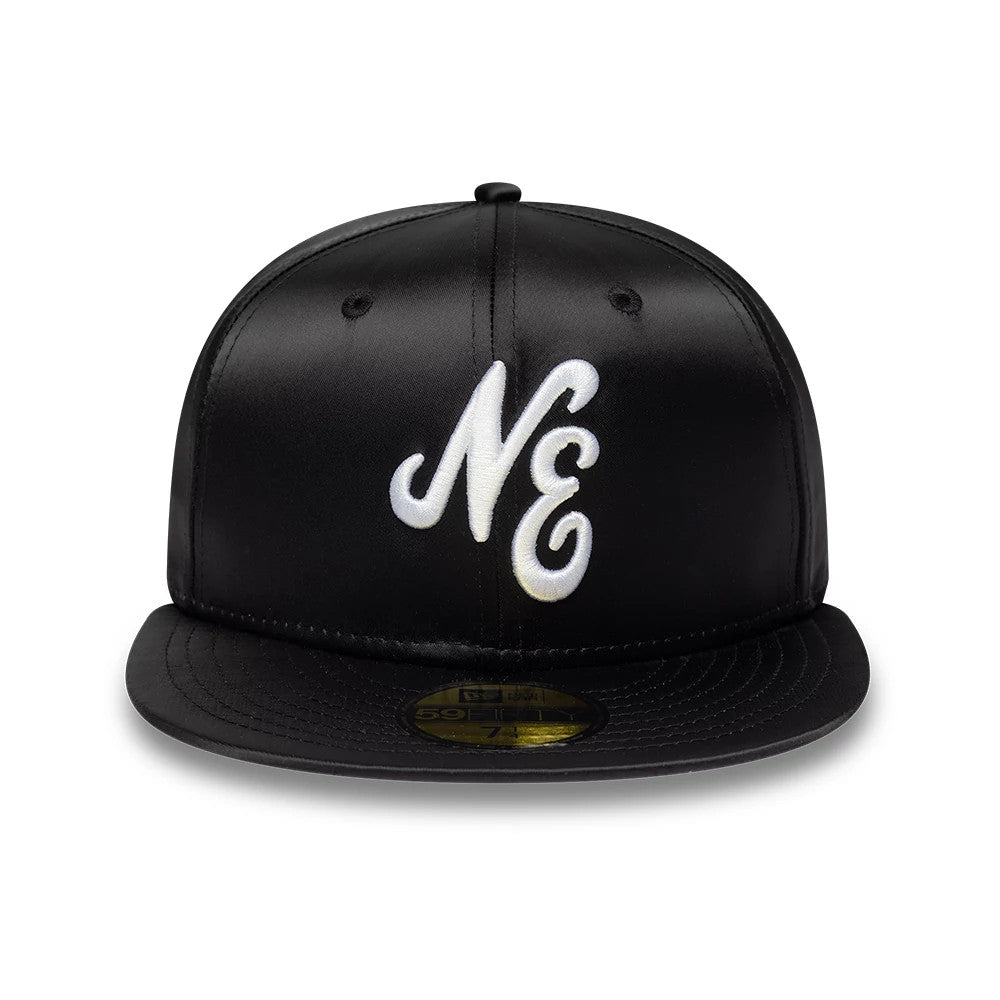 New Era Satin Black 59FIFTY Fitted Cap, front view showing the large white embroidered NE logo on the structured black crown, black flat visor, and gold 59FIFTY size sticker on the centre of the visor.