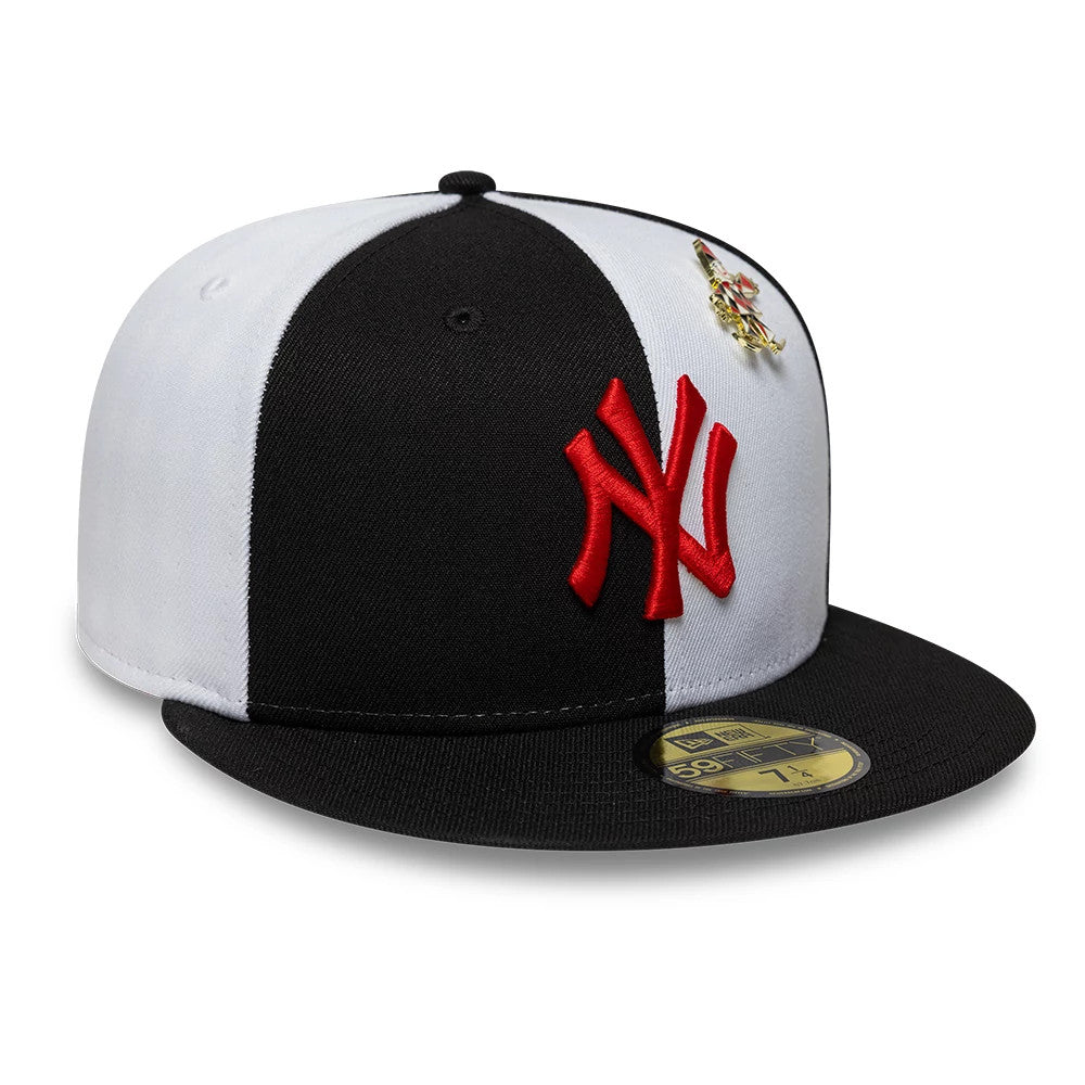 New York Yankees MLB Pinwheel Black New Era 59FIFTY Fitted Cap, three-quarter view showing a large red embroidered NY logo on the front black panel, contrasting with white panels, and a gold 59FIFTY size sticker on the black flat visor.