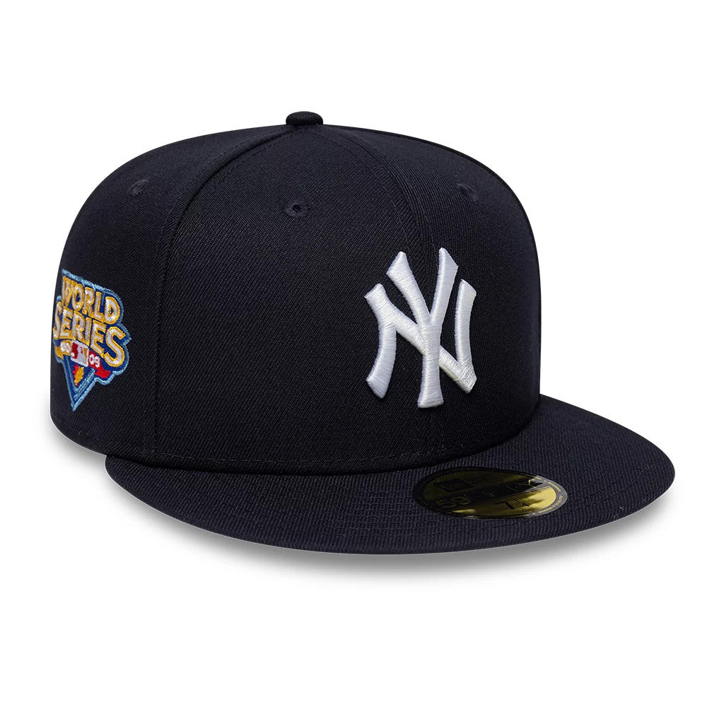 New York Yankees MLB Sidepatch Satin Lined Navy New Era 59FIFTY Fitted Cap, three-quarter view showing the raised white Yankees logo on the front panel, a colourful World Series side patch, and a black visor with a gold 59FIFTY size sticker.
