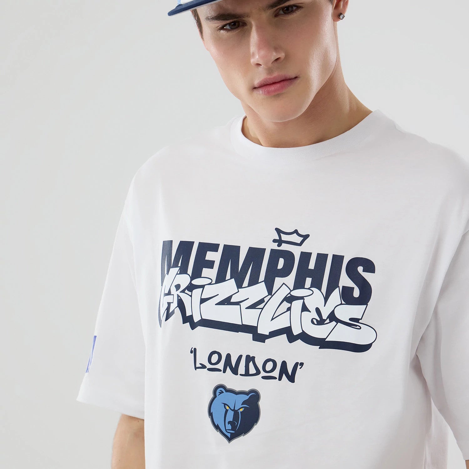 The model is wearing this NBA London Game 2026 Memphis Grizzlies Oversized T-Shirt in white. 3