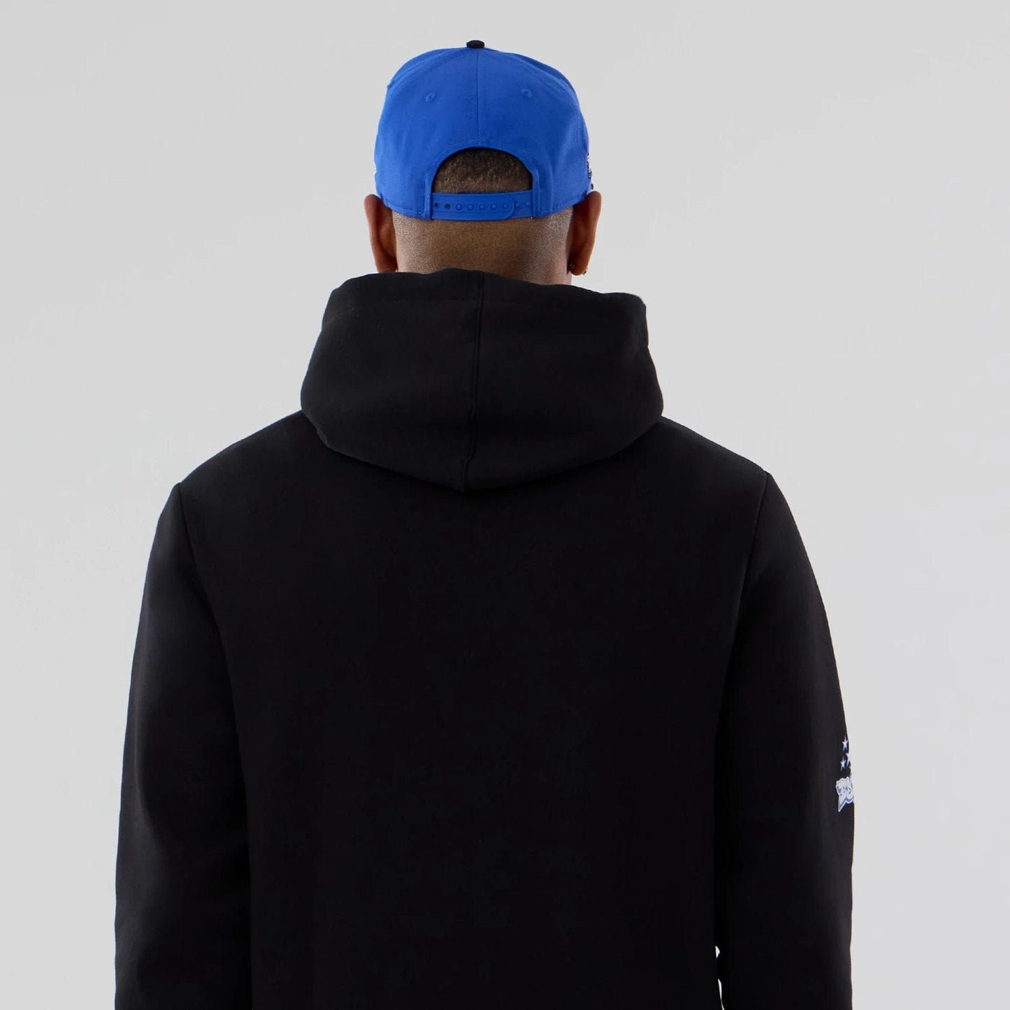 The model is wearing this NBA Berlin Game 2026 Orlando Magic Pullover Hoodie in black. 7