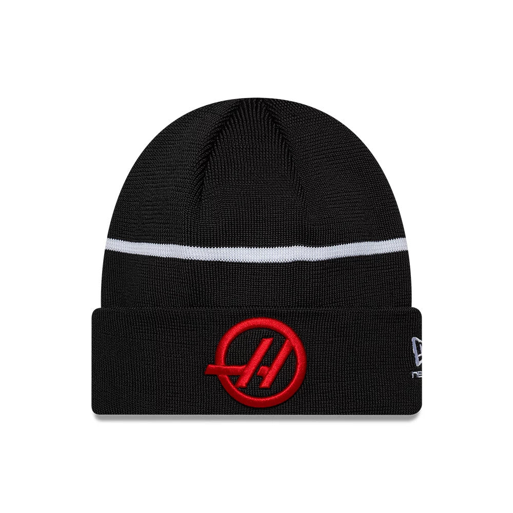 New Era TGR Haas F1 Team Black Cuff Knit Beanie Hat, front view showing a red raised embroidered team logo on the cuff, a contrasting white stripe around the crown, and the New Era flag logo on the left side.