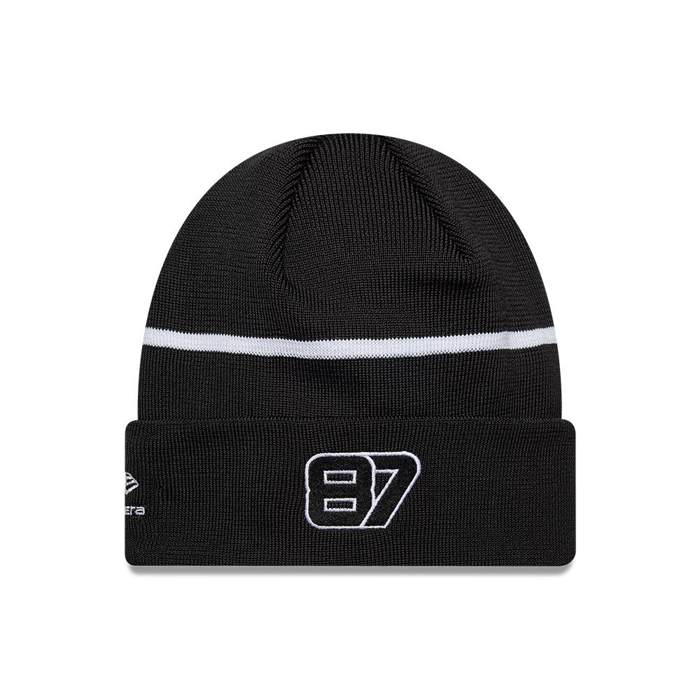 New Era TGR Haas F1 Oliver Bearman Black Cuff Knit Beanie Hat, front view showing the white embroidered number 87 on the cuff, a white stripe across the ribbed black crown, and the New Era flag logo on the left side.