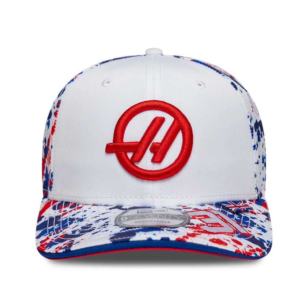 TGR Haas F1 Esteban Ocon Silverstone Race Special White New Era 9SEVENTY Stretch Snap Cap, front view showing the red raised embroidered A logo on the white front panel, with a splatter print visor in blue and red and a 9SEVENTY size sticker.