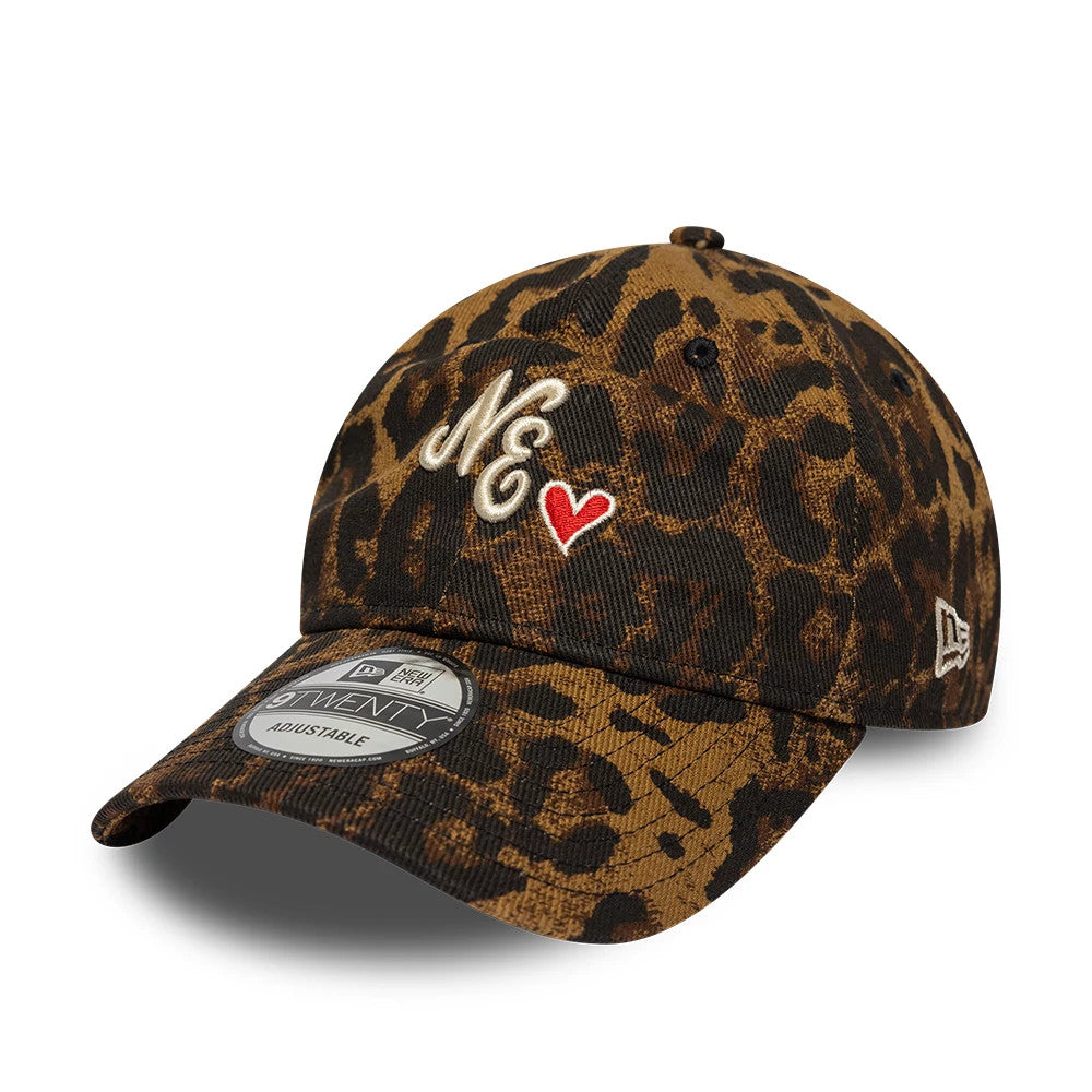 New Era Leopard Heart Brown 9TWENTY Adjustable Cap, three-quarter view showing the cream embroidered NE and red heart on the front panel, with a leopard print pattern across the unstructured crown, black-visor, and 9TWENTY size sticker.