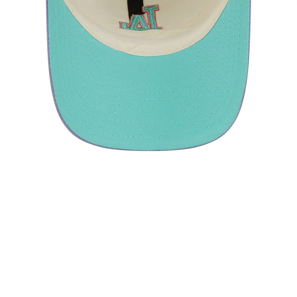 New Era LA Dodgers MLB Lavender Flowers White Casual Classic Adjustable Cap, inside view showing the cream sweatband and aqua undervisor with purple edging, featuring an embroidered LA logo in blue and pink on the panel above the sweatband.