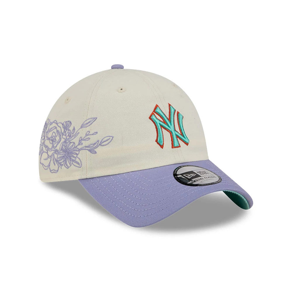 New Era New York Yankees MLB Lavender Flowers White Casual Classic Adjustable Cap, three-quarter view showing the turquoise and red embroidered NY logo on the front panel, lavender floral embroidery on the side.
