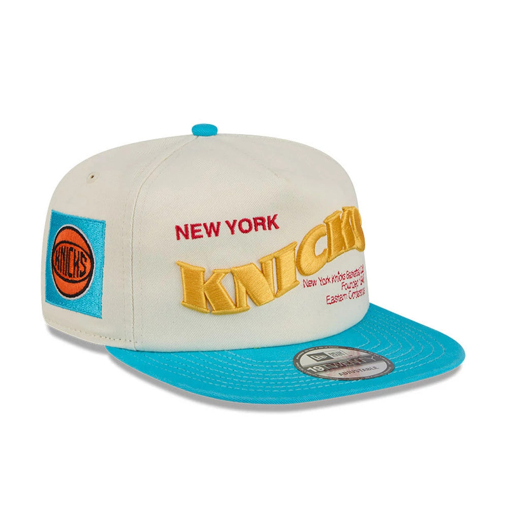 New York Knicks NBA Conference Script White New Era 19TWENTY Adjustable Cap, three-quarter view showing the raised yellow Knicks lettering and red New York embroidery on the front panel, with a turquoise visor and the team logo on the left side.