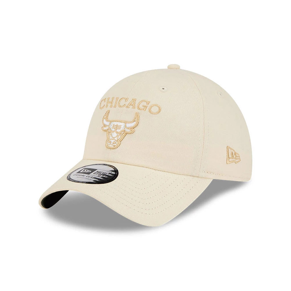 Chicago Bulls NBA Team Logo Beige New Era Casual Classic Adjustable Cap, three-quarter view showing beige embroidered Chicago Bulls logo on the front panel, curved beige visor with a black underside, and New Era flag logo on the left side.