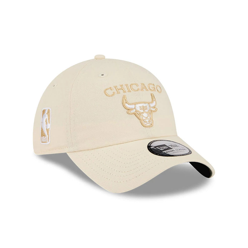 New Era Chicago Bulls NBA Team Logo Beige Casual Classic Adjustable Cap, three-quarter view showing the raised beige embroidered Chicago Bulls logo on the front panel, NBA logo on the left side, and a curved beige visor with a black underside.