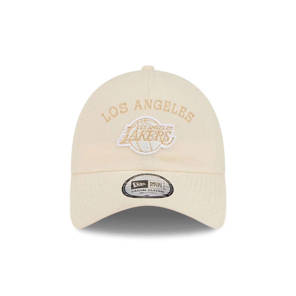 New Era LA Lakers NBA Team Logo White Casual Classic Adjustable Cap, front view showing white raised embroidery of the Los Angeles Lakers logo on the structured white crown, with a curved visor and a New Era Casual Classic size sticker on the visor.