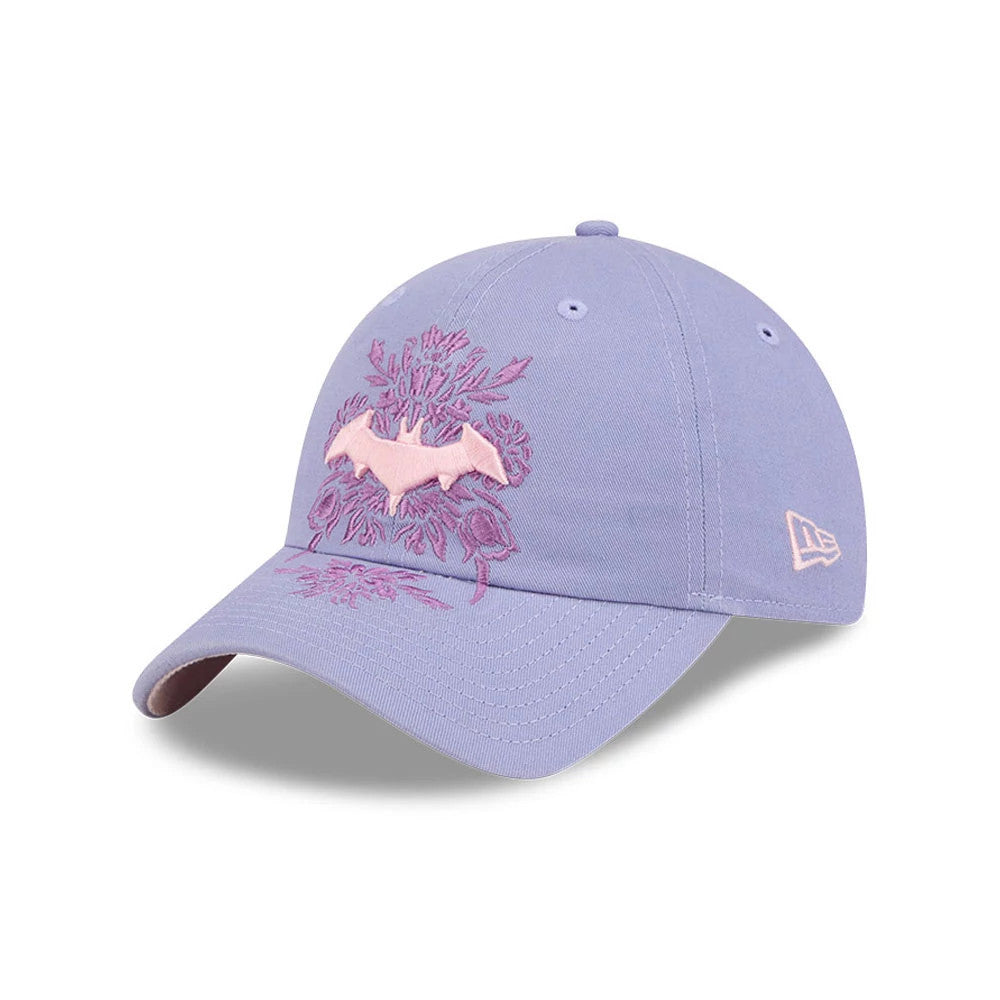 New Era Womens DC Batgirl Pastel Purple Casual Classic Adjustable Cap, front view showing the pink bat emblem and floral embroidery on the crown, with a curved pastel purple visor and the New Era flag logo embroidered in pink on the left side.