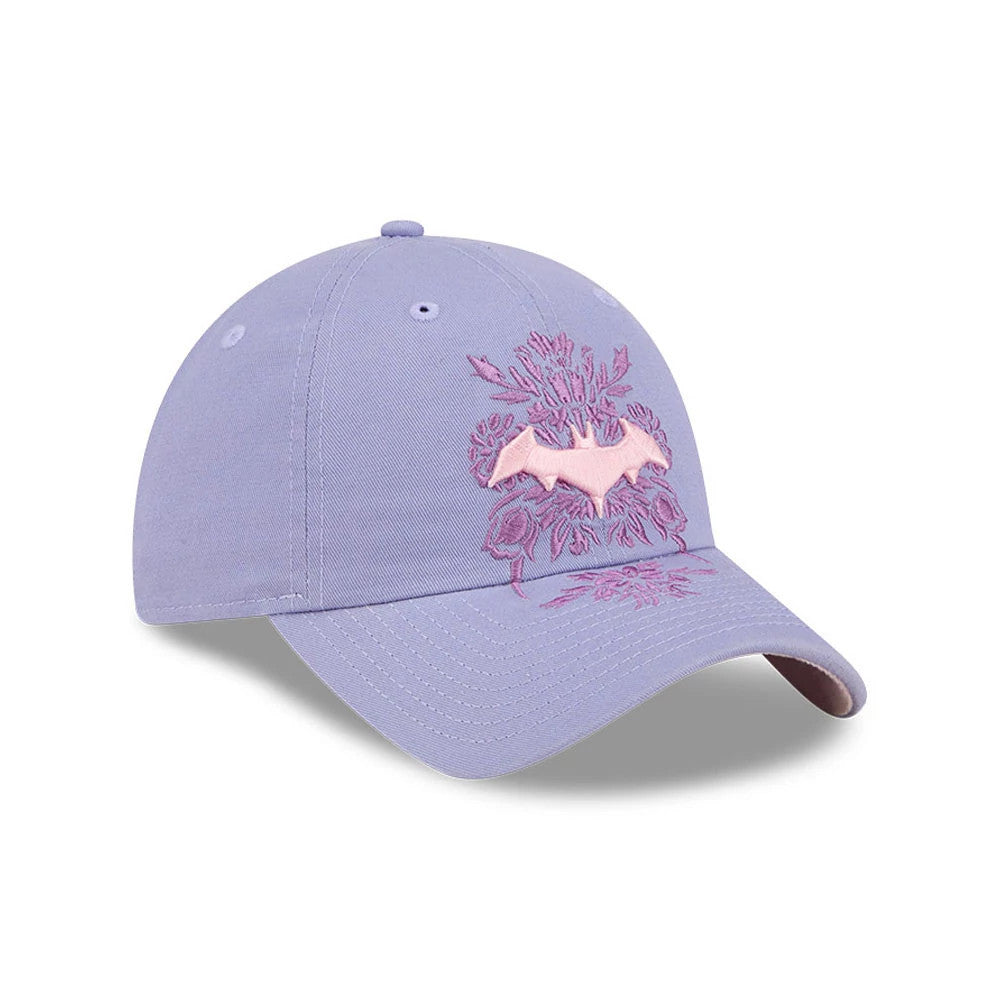 New Era Womens DC Batgirl Pastel Purple Casual Classic Adjustable Cap, three-quarter view showing the pink embroidered Batgirl logo on the front panel surrounded by floral embroidery, with a curved purple visor and matching top button.