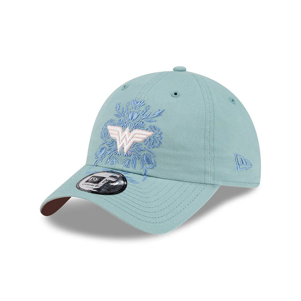 New Era Womens DC Wonder Woman Pastel Blue Casual Classic Adjustable Cap, three-quarter view showing a raised Wonder Woman logo with floral embroidery on the front panel, a curved visor with a 9FORTY size sticker.