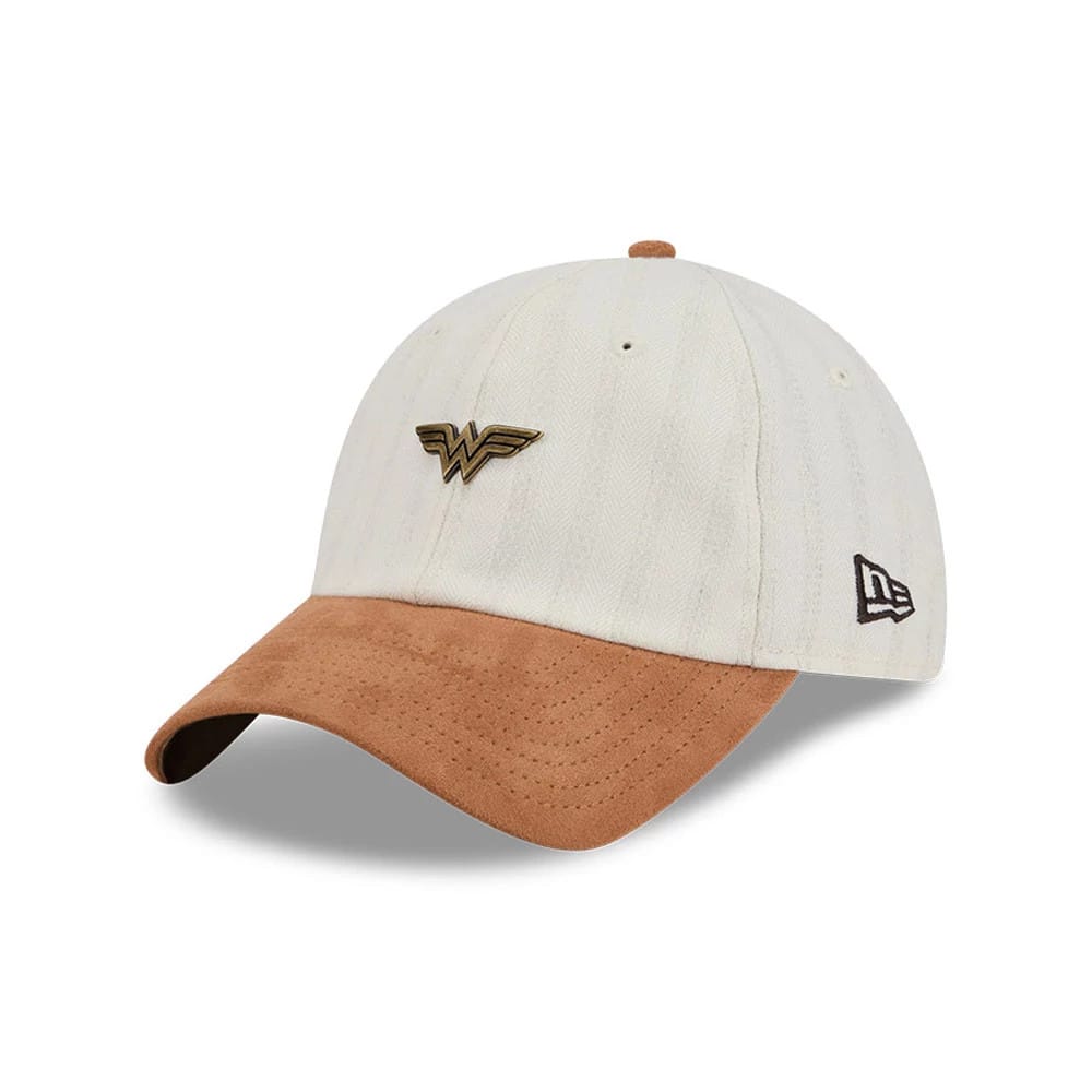 New Era Womens DC Wonder Woman White Casual Classic Adjustable Cap, three-quarter view showing the gold Wonder Woman logo in raised embroidery on the front panel, a brown suede curved visor, and the black and white New Era flag logo on the left side.