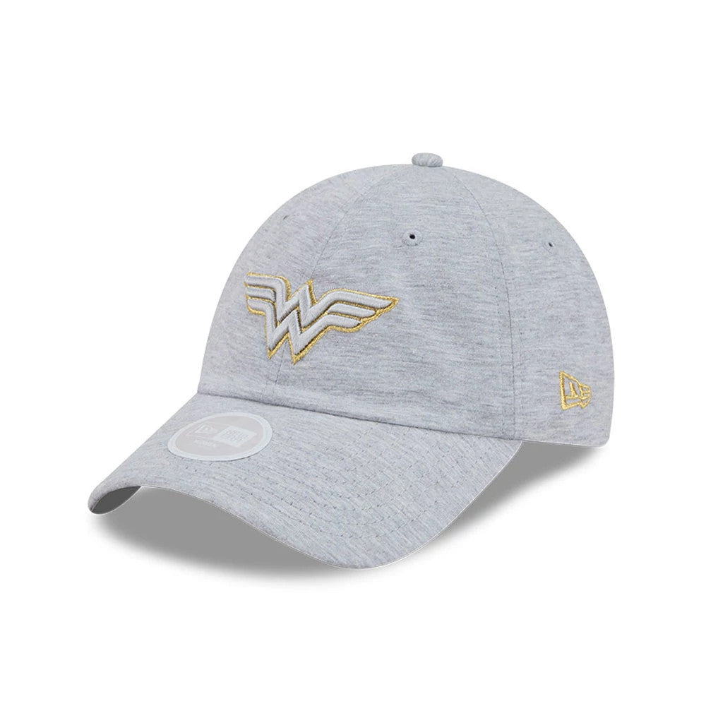 Womens DC Wonder Woman Grey New Era Open Back Cap, three-quarter view showing the gold Wonder Woman logo embroidered on the front panel, a curved grey visor with a 9FORTY size sticker, and the New Era flag logo on the left side.