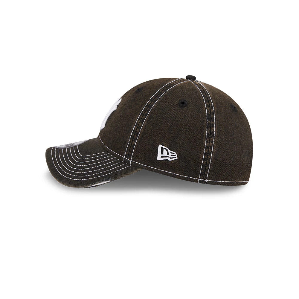 New York Yankees MLB Stencil Distressed Black New Era 9TWENTY Adjustable Cap, side view showing the white New Era flag logo on the left side, with white contrast stitching and a curved visor.