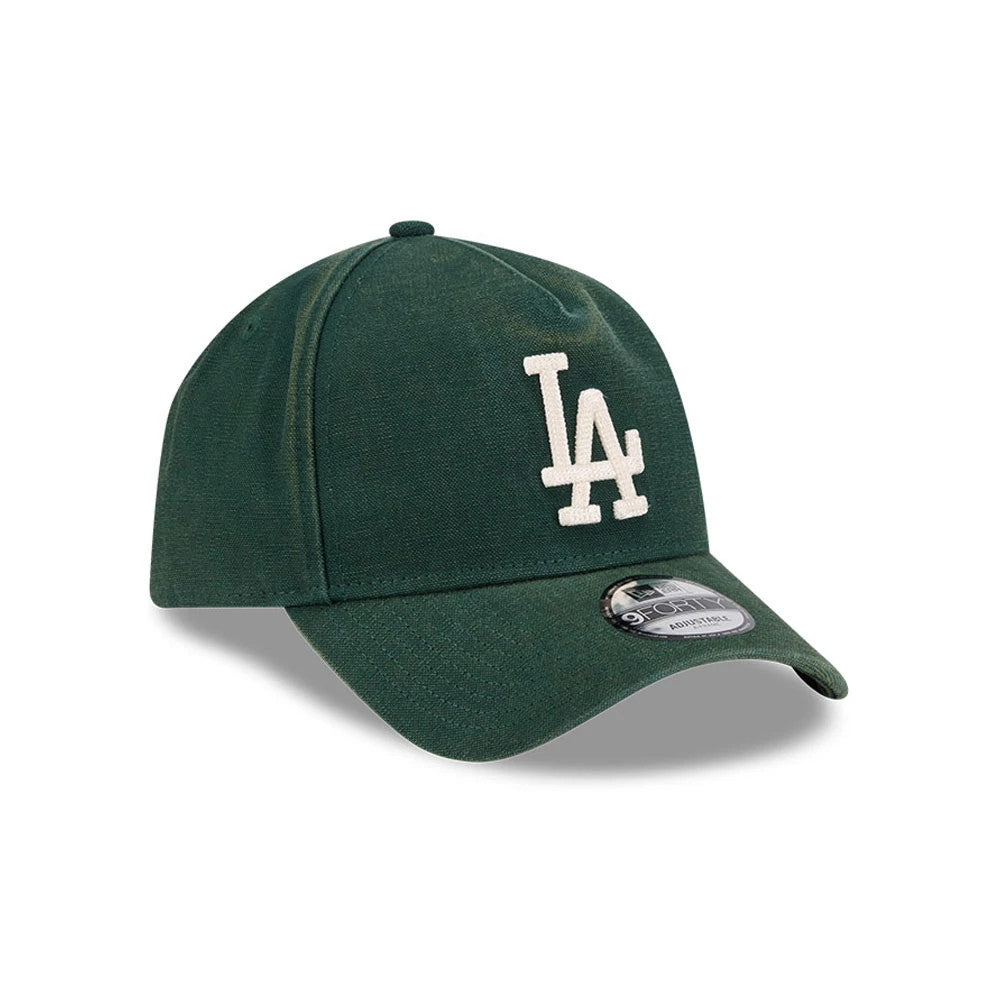 LA Dodgers MLB Washed Canvas Dark Green New Era 9FORTY A-Frame Adjustable Cap, front view showing the raised white embroidered LA logo on the front panel, with a curved dark green visor featuring a 9FORTY size sticker.