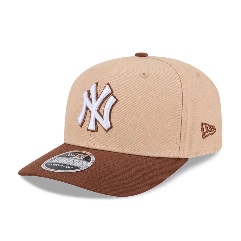 Yankees MLB Candied Pecan Beige New Era 9SEVENTY Stretch Snap Adjustable Cap, three-quarter view showing the raised white and brown embroidered NY logo on the front panel, brown curved visor, and New Era flag logo on the left side.