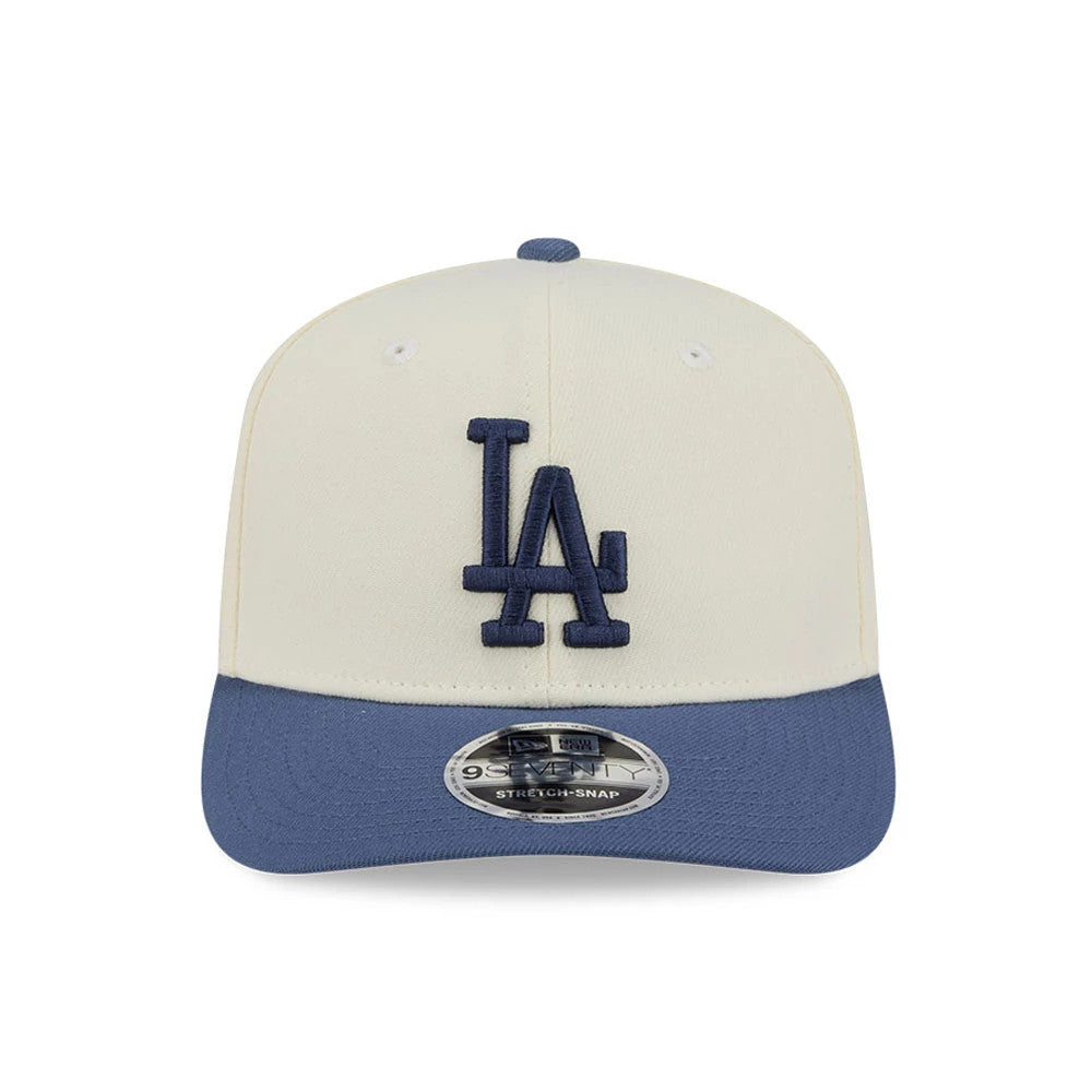 Dodgers MLB Slate Stone Cream & Dark Blue New Era 9SEVENTY Stretch Snap Adjustable Cap, front view showing the dark blue embroidered LA logo on the cream front panel, with a dark blue visor and 9SEVENTY size sticker on the visor.