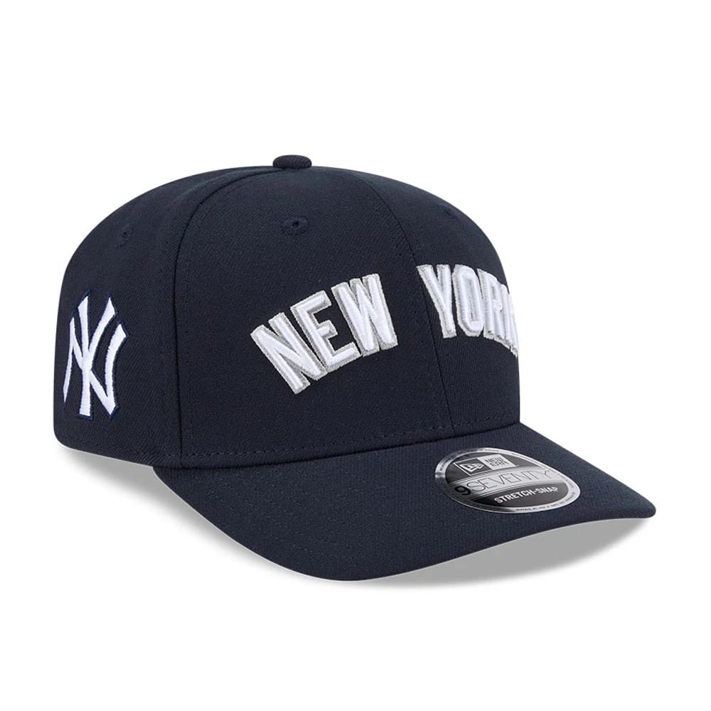 New York Yankees MLB Navy New Era 9SEVENTY Stretch Snap Adjustable Cap, front three-quarter view showing the white embroidered New York lettering on the navy crown, white NY logo on the left side, and 9SEVENTY size sticker on the curved visor.