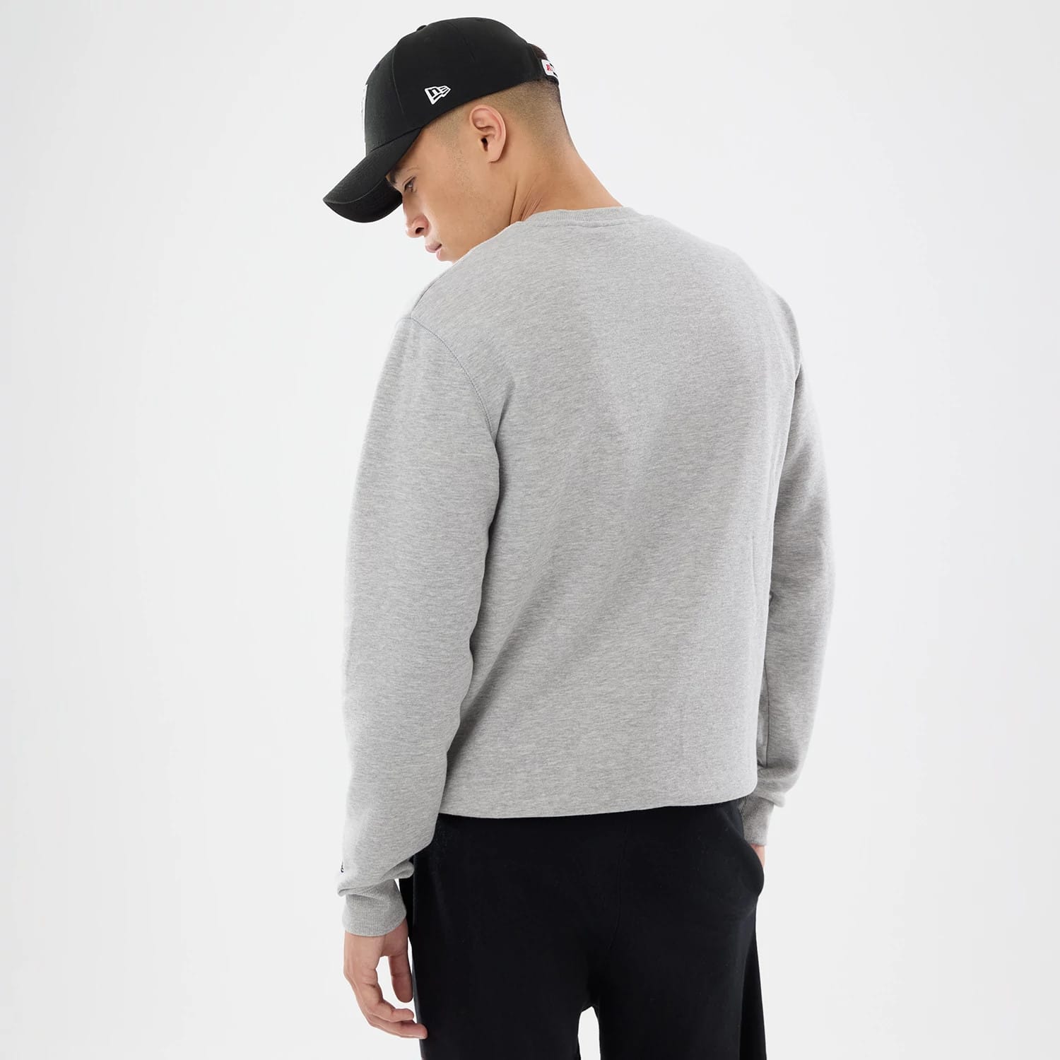 The model is wearing this NFL Training 2026 Las Vegas Raiders Crew Neck Sweater in grey. 2