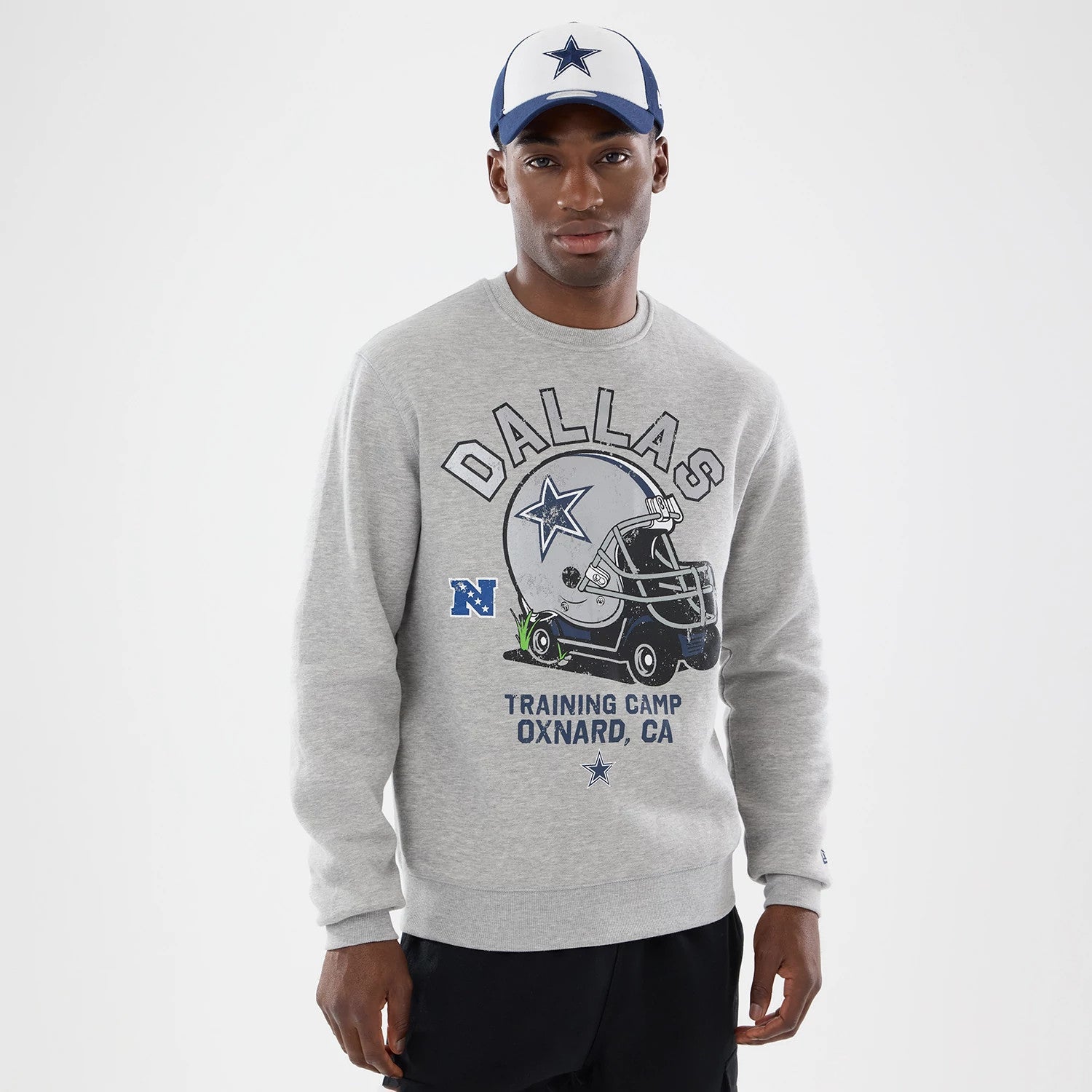 The model is wearing this NFL Training 2026 Dallas Cowboys Crew Neck Sweater in grey. 1