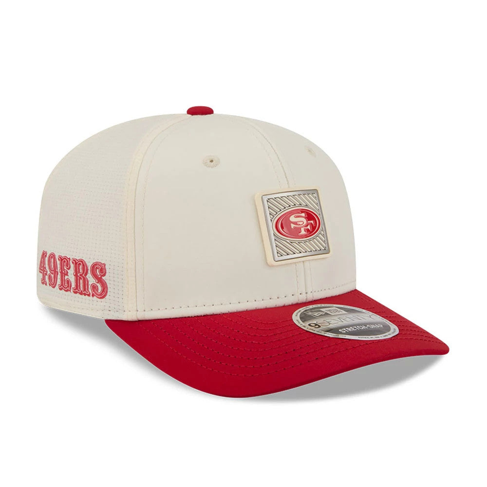 49ers NFL Training 2026 White New Era 9SEVENTY Stretch Snap Adjustable Cap, three-quarter view showing a square 49ers emblem sewn onto the front panel, a red visor with an open 9SEVENTY size sticker, and red 49ERS embroidery on the left side.