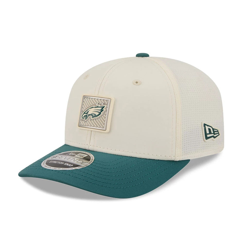 Eagles NFL Training 2026 White New Era 9SEVENTY Stretch Snap Adjustable Cap, three-quarter view showing a raised embroidered Eagles logo on the front panel, a contrast teal visor with a 9SEVENTY size sticker, and a New Era flag logo on the left side.