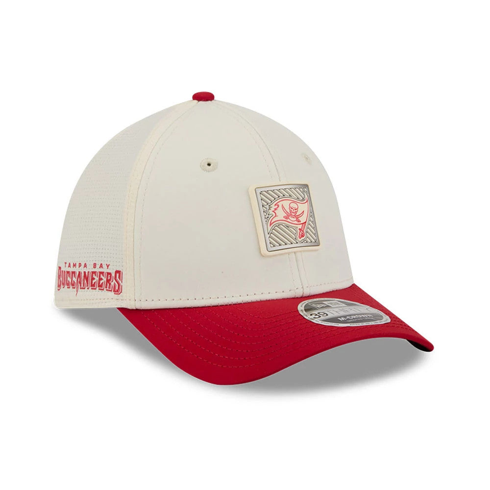 Buccaneers NFL Training 2026 White New Era 39THIRTY M-Crown Stretch Fit Cap, three-quarter view showing a red and white Buccaneers logo patch on the front panel, red visor with a 39THIRTY size sticker, and an embroidered team name on the left side.