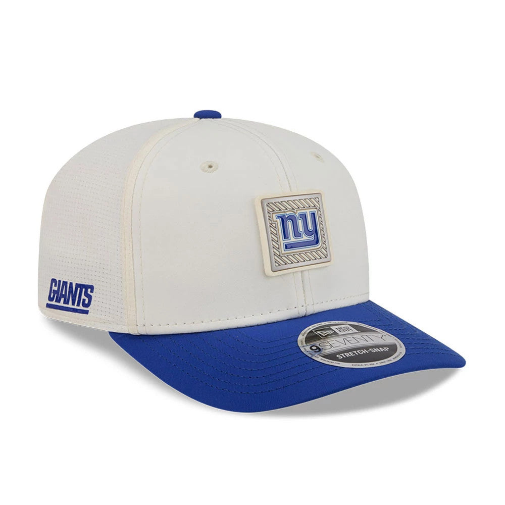 New York Giants NFL Training 2026 White New Era 9SEVENTY Stretch Snap Adjustable Cap, three-quarter view showing a raised embroidered blue NY logo on the front panel, contrasted by a royal blue visor with a 9SEVENTY size sticker.