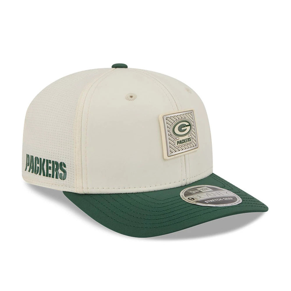 Packers NFL Training 2026 White New Era 9SEVENTY Stretch Snap Adjustable Cap, three-quarter view showing a raised Green Bay Packers logo patch on the front panel, dark green visor, and 9SEVENTY size sticker on the visor.