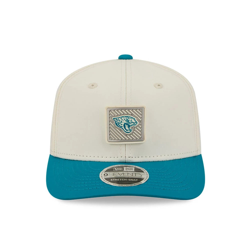 Jaguars NFL Training 2026 White New Era 9SEVENTY Stretch Snap Adjustable Cap, front view showing the raised Jaguars emblem on the front panel, teal curved visor with a 9SEVENTY size sticker, and matching teal top button.