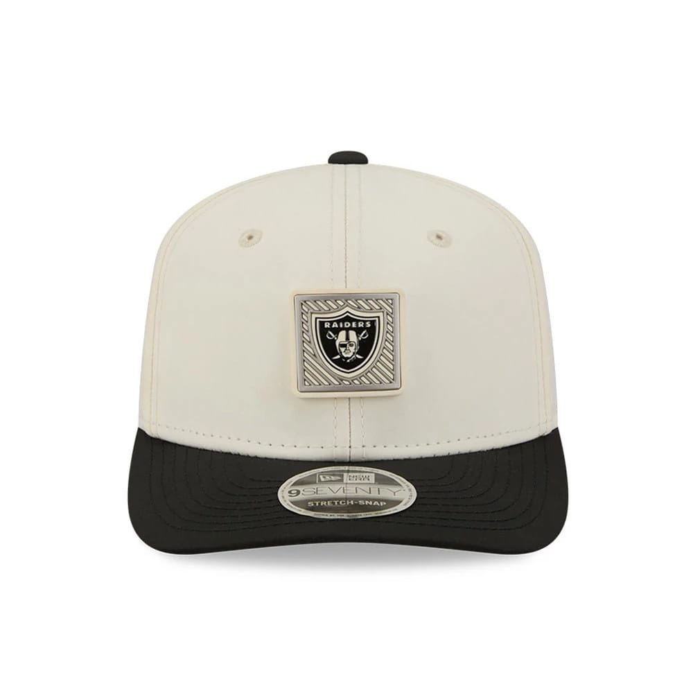 Raiders NFL Training 2026 White New Era 9SEVENTY Stretch Snap Adjustable Cap, front view showing the raised rectangular Raiders logo badge on the front panel, with a contrasting black curved visor and a 9SEVENTY size sticker on the visor.