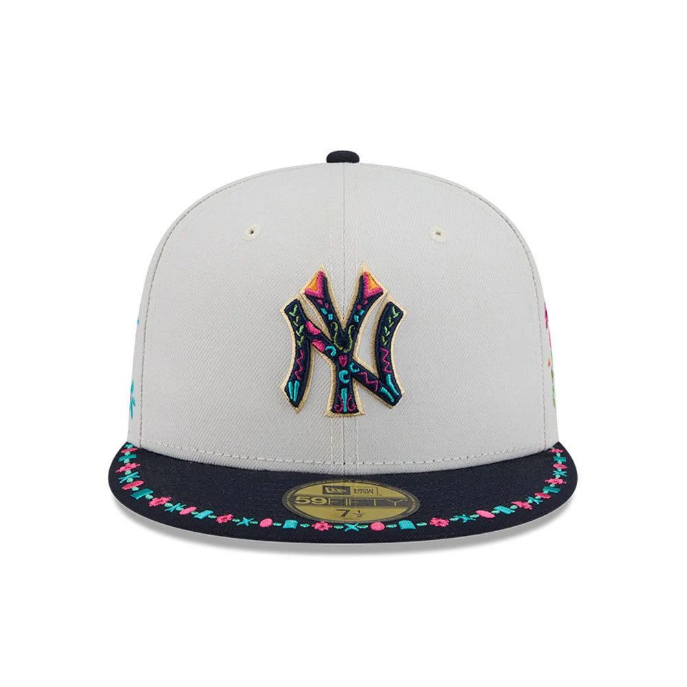 New York Yankees MLB Heritage Light Beige New Era 59FIFTY Fitted Cap, front view showing a multicoloured embroidered Yankees logo on the light beige front panel, with a dark flat visor featuring colourful decorative stitching.
