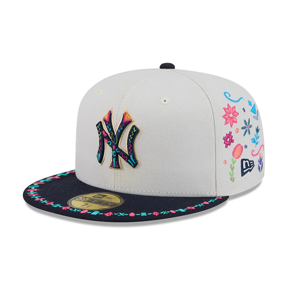 New York Yankees MLB Heritage Light Beige New Era 59FIFTY Fitted Cap, three-quarter view showing colourful Yankee logo with intricate embroidery on beige panels, eyelets on top, a dark visor with floral detail and gold 59FIFTY size sticker.