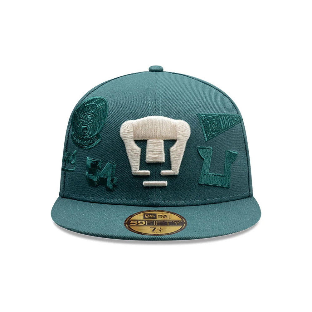 Pumas Unam Liga MX All Over Dark Green New Era 59FIFTY Fitted Cap, front view showing a large white embroidered Pumas logo on the structured green crown, various dark green embroidered team graphics, and a gold 59FIFTY size sticker on the flat visor.