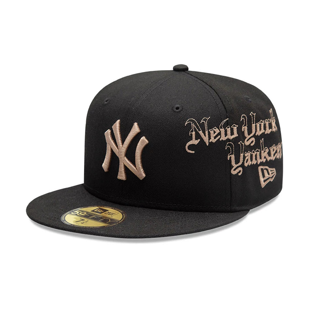New York Yankees MLB Heritage Black New Era 59FIFTY Fitted Cap, three-quarter view showing beige embroidered NY logo on the front panel, gothic New York Yankees text on the side, and a gold 59FIFTY size sticker on the black visor.